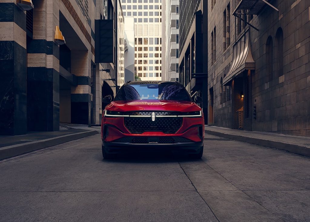 A red 2026 Lincoln Nautilus SUV driving on the road.