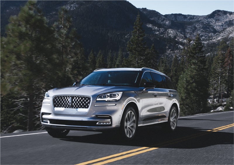 A 2023 Lincoln Aviator® Grand Touring SUV being driven on a winding road to demonstrate the capabilities of all-wheel drive | Parkway Lincoln in Winston Salem NC