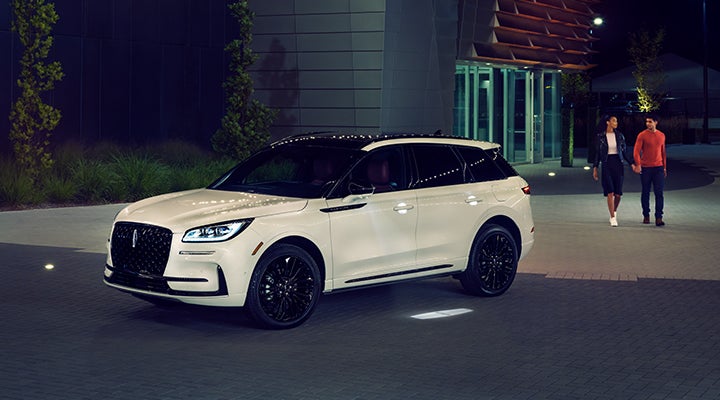 Two people approach a 2024 Lincoln Corsair® SUV featuring the available Jet Appearance Package. | Parkway Lincoln in Winston Salem NC