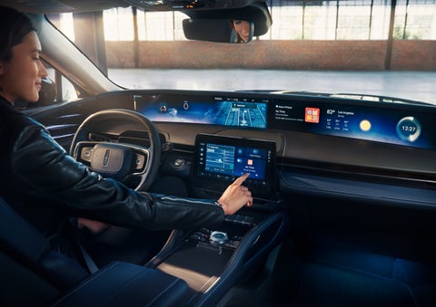 The driver of a 2024 Lincoln Nautilus® SUV interacts with the center touchscreen. | Parkway Lincoln in Winston Salem NC