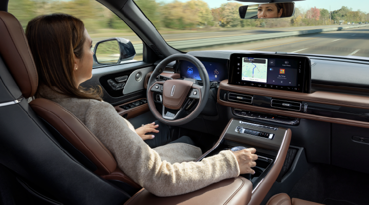 A woman is seen sitting in the driver’s seat of her 2025 Lincoln Aviator® SUV with her hands off the steering wheel. | Parkway Lincoln in Winston Salem NC
