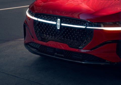 The available front LED light bar and center Lincoln Star logo glow at dusk. | Parkway Lincoln in Winston Salem NC