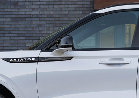 The driver’s side door and fender badging of a white 2026 Lincoln Aviator® SUV are showcased. | Parkway Lincoln in Winston Salem NC