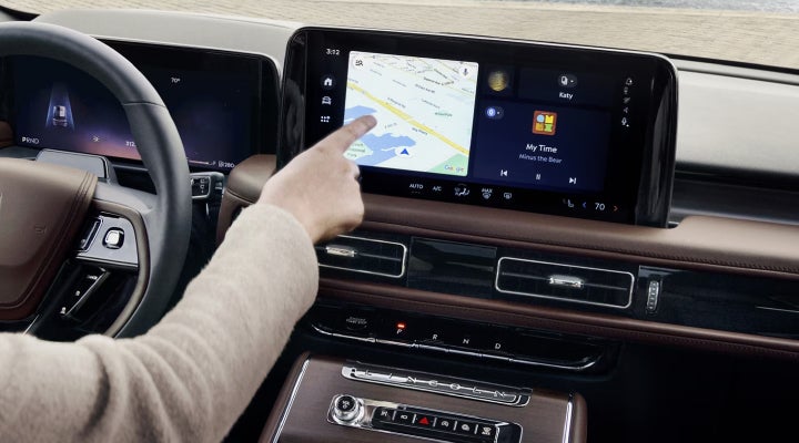 A person is tapping the center display touchscreen of a 2026 Lincoln Aviator® SUV. | Parkway Lincoln in Winston Salem NC