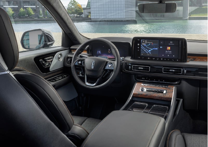 The interior of the 2026 Lincoln Aviator® SUV is shown parked with a view of a harbor through the windshield. | Parkway Lincoln in Winston Salem NC