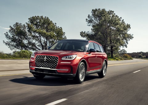 A 2026 Lincoln Corsair® SUV is shown being driven on a country road. | Parkway Lincoln in Winston Salem NC