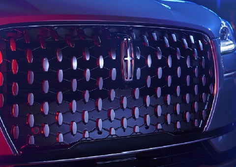 The grille of a 2025 Lincoln Corsair&reg; SUV reflects neon light at night. | Parkway Lincoln in Winston Salem NC