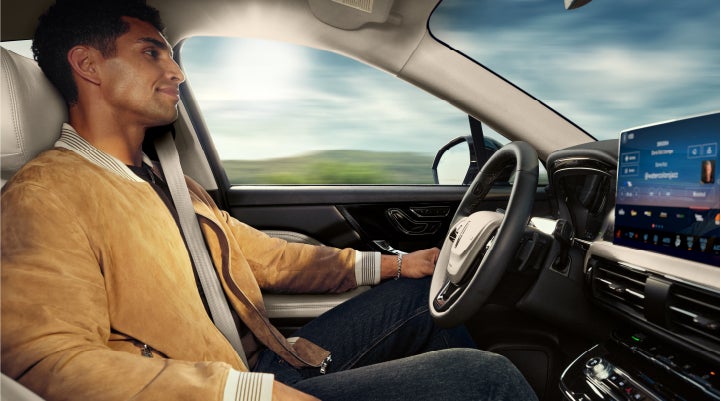 A person is shown using Lincoln BlueCruise hands-free highway driving technology on a divided highway in a hands-free Blue Zone. | Parkway Lincoln in Winston Salem NC
