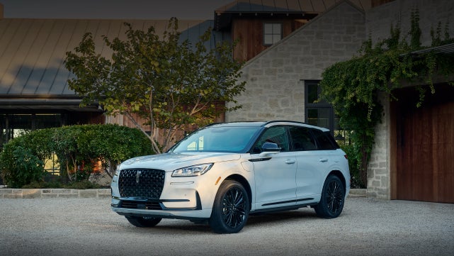 A 2026 Lincoln Corsair® SUV is parked in front off a luxury home. | Parkway Lincoln in Winston Salem NC