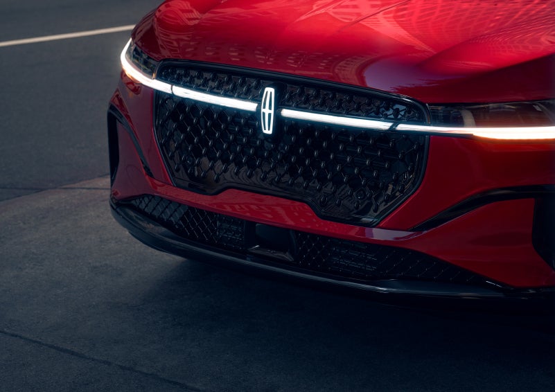 The available front LED light bar and center Lincoln Star logo glow at dusk. | Parkway Lincoln in Winston Salem NC