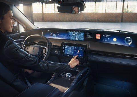 The driver of a 2026 Lincoln Nautilus® SUV interacts with the center touchscreen. | Parkway Lincoln in Winston Salem NC