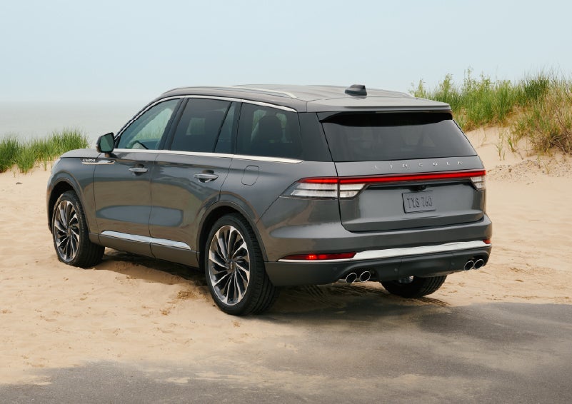 A 2027 Lincoln Aviator® SUV is parked next to sand dunes. | Parkway Lincoln in Winston Salem NC