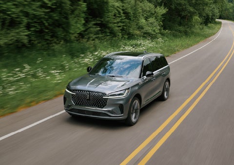 A 2027 Lincoln Aviator® SUV is being driven down a road. | Parkway Lincoln in Winston Salem NC
