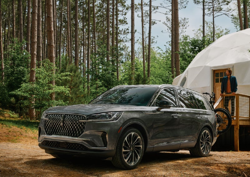 A 2027 Lincoln Aviator® is parked next to a high end glamping site. | Parkway Lincoln in Winston Salem NC