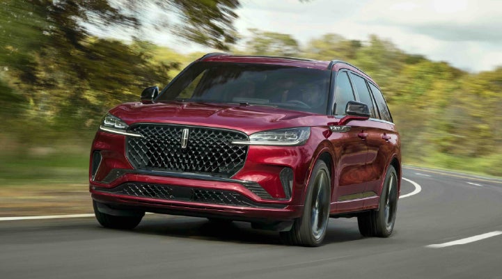 A 2027 Lincoln Aviator® SUV is being driven on a country road | Parkway Lincoln in Winston Salem NC
