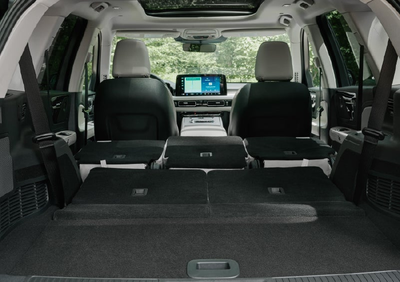 A rear to front view of the interior of a 2027 Lincoln Aviator® Black Label™ SUV shows the third and second rows folded flat | Parkway Lincoln in Winston Salem NC