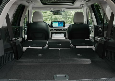 A rear to front view of the interior of a 2027 Lincoln Aviator® Black Label™ SUV shows the third and second rows folded flat | Parkway Lincoln in Winston Salem NC