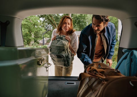 A couple loads luggage into the rear of a 2027 Lincoln Aviator® Black Label™ SUV..e 202 | Parkway Lincoln in Winston Salem NC