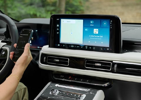 A person pairs thier phone with the center touchscreen of a 2027 Lincoln Aviator® Black Label™ SUV | Parkway Lincoln in Winston Salem NC