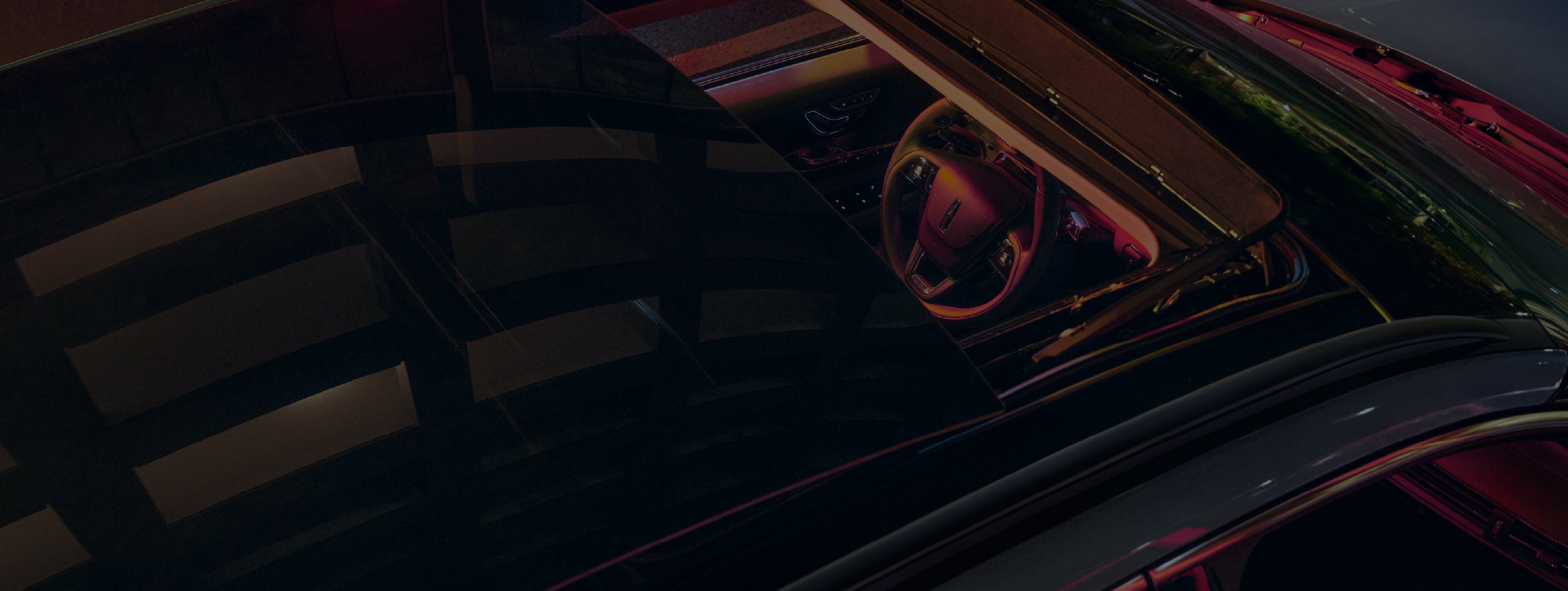 A close-up of the top of a 2026 Lincoln Corsair® Grand Touring SUV and interior seen through the panoramic Vista Roof®.
