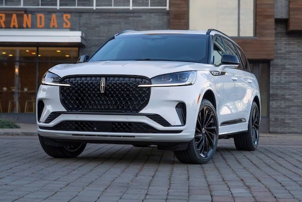 A white 2026 Lincoln Aviator Reserve Parked in front of a restaurant